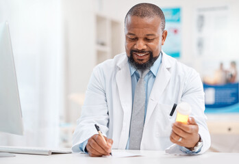 Fototapeta premium This will provide the relief you need. Shot of a mature doctor writing notes while holding a bottle of tablets in a medical office.