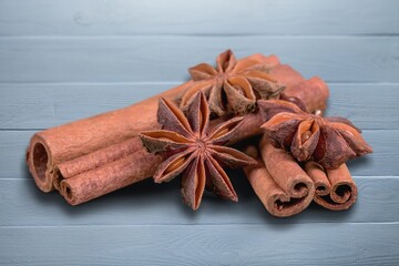 Cinnamon sticks and heap of powder on desk