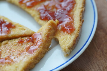 Food in shape of a French toast with Marmelade or strawberry jam