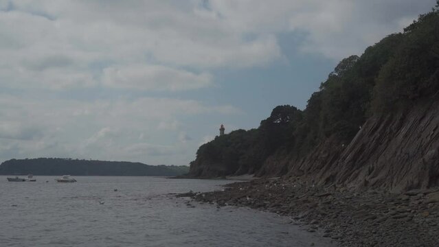 Phare Du Portzic lighthouse and the rocky shore of the ocean in the French city of Brest. View of the Phare du petit minou in Plouzane, Brittany, France. Portic Lighthouse. 