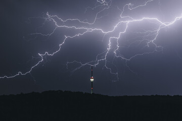 TV tower at night during a thunderstorm