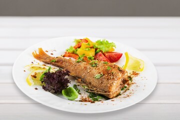 Fried salmon with vegetableson plate. Sprinkled with sesame seeds.