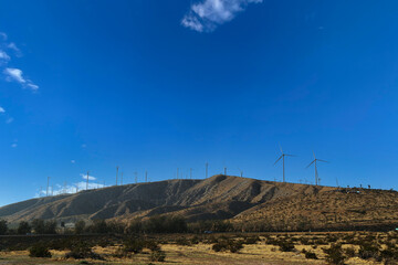 wind farm turbine hillside mountain top energy power sustainable turbines clear atmosphere landscape