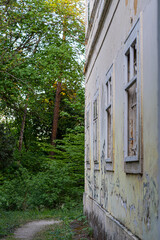 old weathered building with vintage windows in the park, countryside, Slovakia