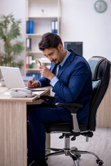 Young male employee working in the office