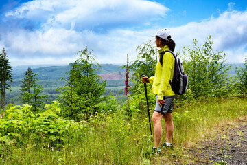 Woman looking out to vast wilderness while hiking