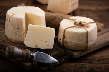 Italian cheese on wooden cutting board
