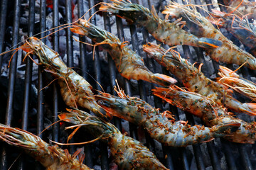 jumbo prawns or shrimps on a barbeque grill fire