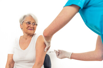 Happy caucasian grandmother being vaccinated over white background. High quality photo