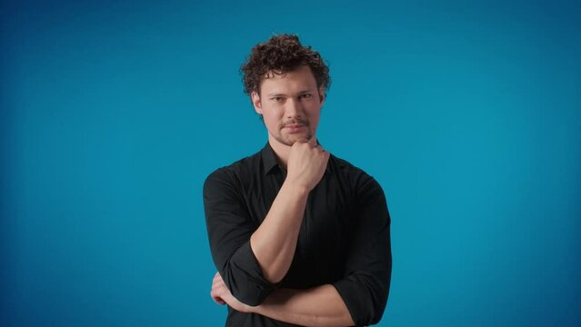 Portrait confident brutal male attentively listening agree nod posing isolated blue studio