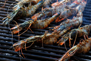 jumbo prawns or shrimps on a barbeque grill fire