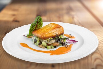 Fried salmon with vegetableson plate. Sprinkled with sesame seeds.