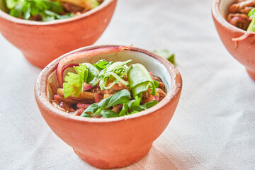 Traditionally made Mexican ceviche. Fish strips with tomato, lettuce, onion, avocado, orange.