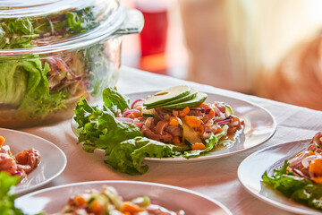 Traditionally made Mexican ceviche. Fish strips with tomato, lettuce, onion, avocado, orange.