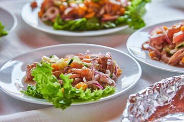 Traditionally made Mexican ceviche. Fish strips with tomato, lettuce, onion, avocado, orange.