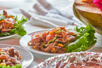 Traditionally made Mexican ceviche. Fish strips with tomato, lettuce, onion, avocado, orange.