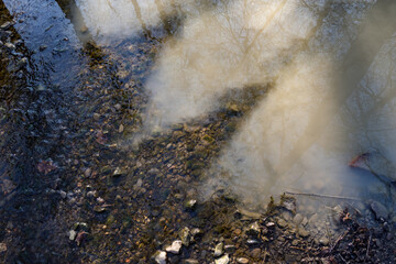 Confluence of two rivers with one being polluted.