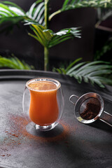 Carrot drink with cinnamon in a glass