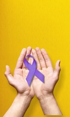 Hands holding purple ribbon on background. International Epilepsy Day. Alzheimer's disease. World...