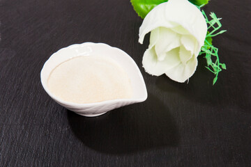 Collagen powder, on black background.