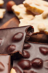 Pieces of tasty chocolate with nuts, closeup