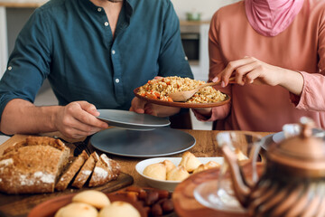 Muslim couple having breakfast together. Celebration of Eid al-Fitr