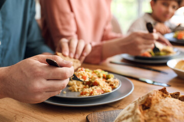 Muslim family having breakfast together, closeup. Celebration of Eid al-Fitr