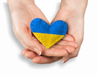 Fototapeta premium Hands holding ukraine flag in form heart