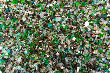 Glass Bay in Vladivostok. Sea-polished colored glass on the beach. Background, texture