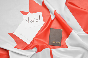 Fototapeta na wymiar Paper sheets with word VOTE and passport on Canadian flag