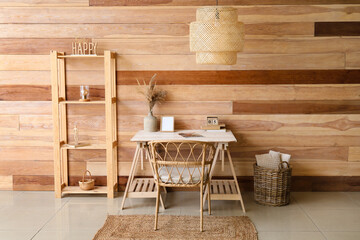 Interior of stylish room with modern workplace, shelving unit and hanging lamp