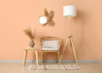 Interior of stylish living room with wicker chair, table and standard lamp