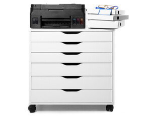 Chest of drawers with printer, stack of folders and blank badge on white background