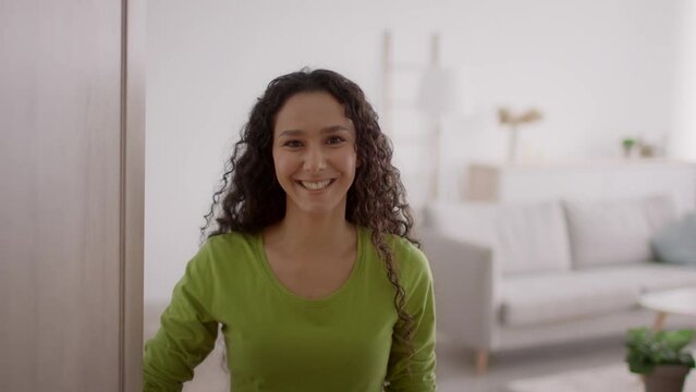 Cheerful Female Opening Door And Talking Standing At Home