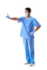 Young African-American doctor in medical mask waggling finger on white background. Immunity concept