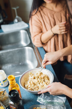 Women Making Tuna Salad Sandwiches In The Kitchen