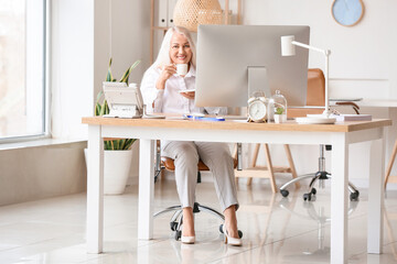 Mature secretary working in office