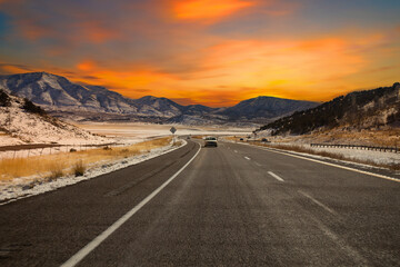 Road trip and snow mountains,  Semi truck Highway in Utah, USA