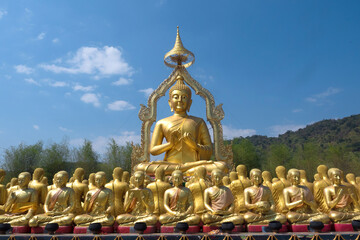 The golden Buddha statue was built outdoors. It is a symbol of the Wednesday religion.