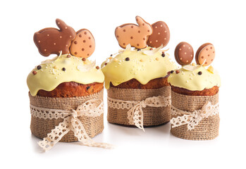 Delicious Easter cakes decorated with cookies on white background