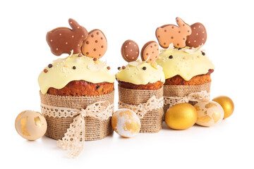 Delicious Easter cakes decorated with cookies and painted eggs on white background