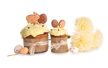 Delicious Easter cakes decorated with cookies and flowers on white background