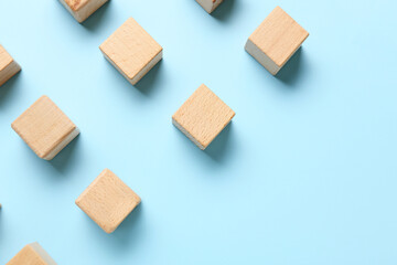 Wooden cubes on blue background