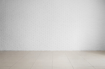 View of white brick wall in big empty room