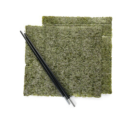 Tasty seaweed sheets and chopsticks isolated on white background
