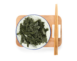 Plate with chopped seaweed sheets and chopsticks on white background © Pixel-Shot