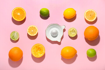 Ceramic juicer and citrus fruits on pink background