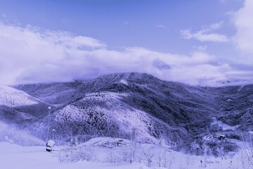 Obraz premium Trendy Very Peri color pantone mist toned mountains. Trendy color Year 2022.