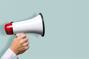 Attention. hand holds loudspeaker which is symbol of advertising,  announcement, warning and...