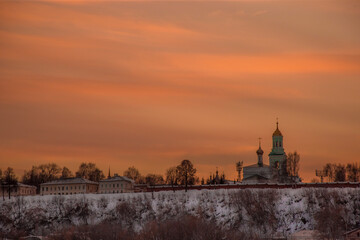 the setting sun beautifully illuminates the clouds over the city on a frosty winter evening